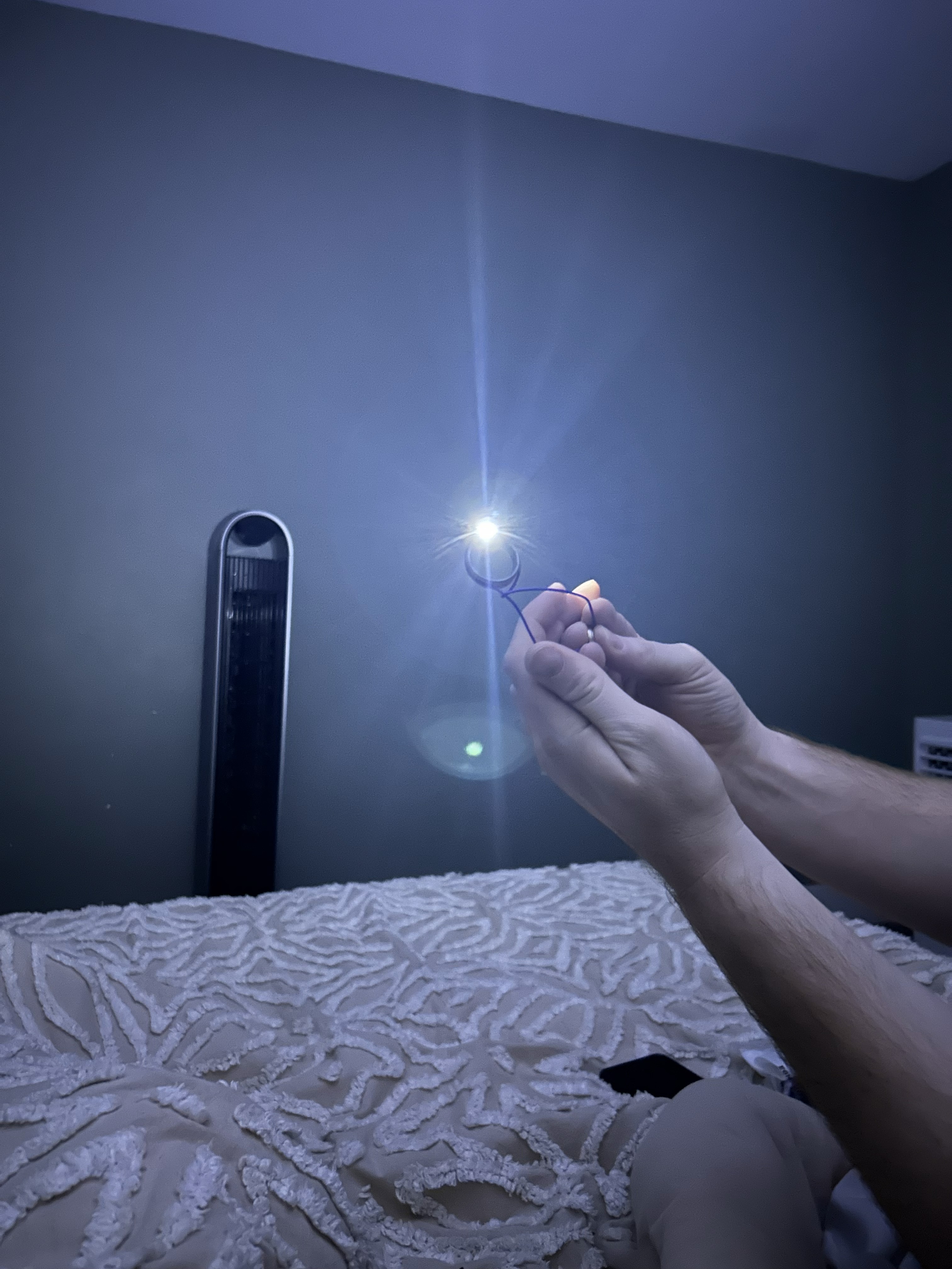 Light Ringz prototype — inventor holding ring emitting a powerful beam of light
