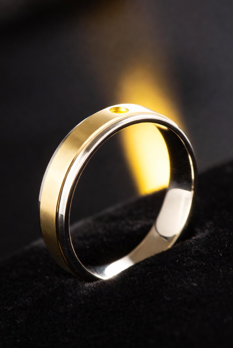 Light Ringz AI concept — gold and silver band with glowing LED on black velvet